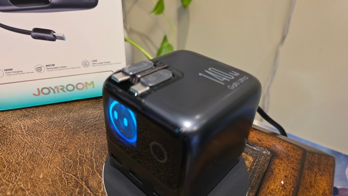 Compact 140W GaN charger featuring retractable cables.